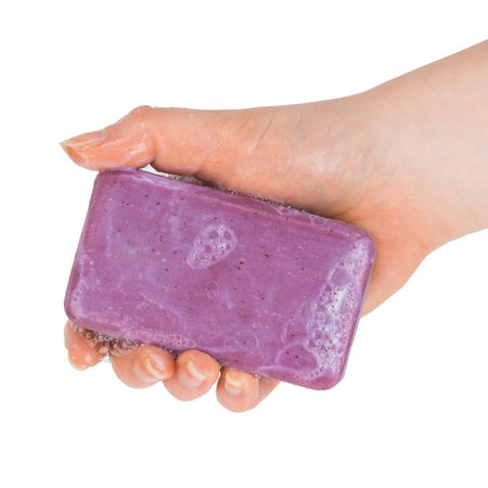 A hand holding a bar of Wine Soap - Vintage Merlot