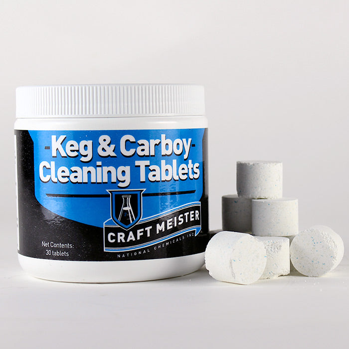 Keg and carboy cleaning tablets in a pile beside its container