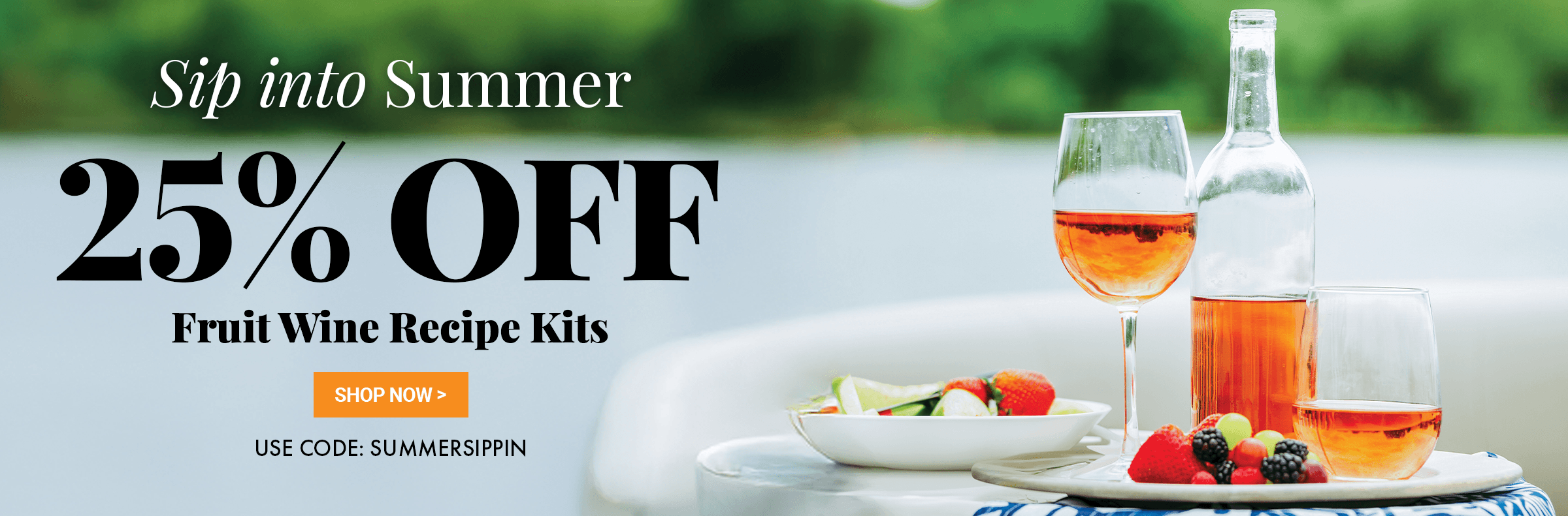 Promotional banner for Sip Into Summer. 20% off Fruit Wine Recipe Kits. Use code: SUMMERSIPPIN with a glass of wine and bottle on a table outdoors.