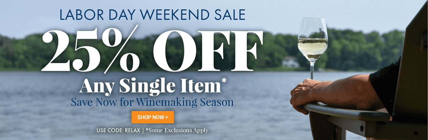 Promotional banner for a Labor Day weekend sale with a person by a lake holding a glass of wine.