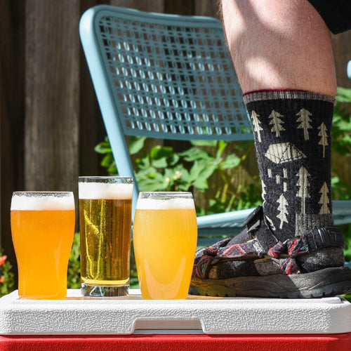 Socks & Sandals Summer Extract Beer Variety Pack with Patrick's Foot wearing socks and sandals on a cooler