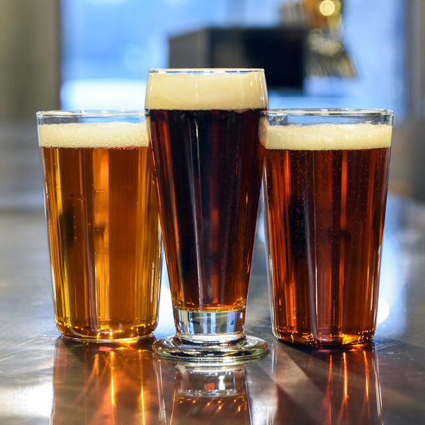 All three beers from The Classics poured into a glasses lineup next to each other.