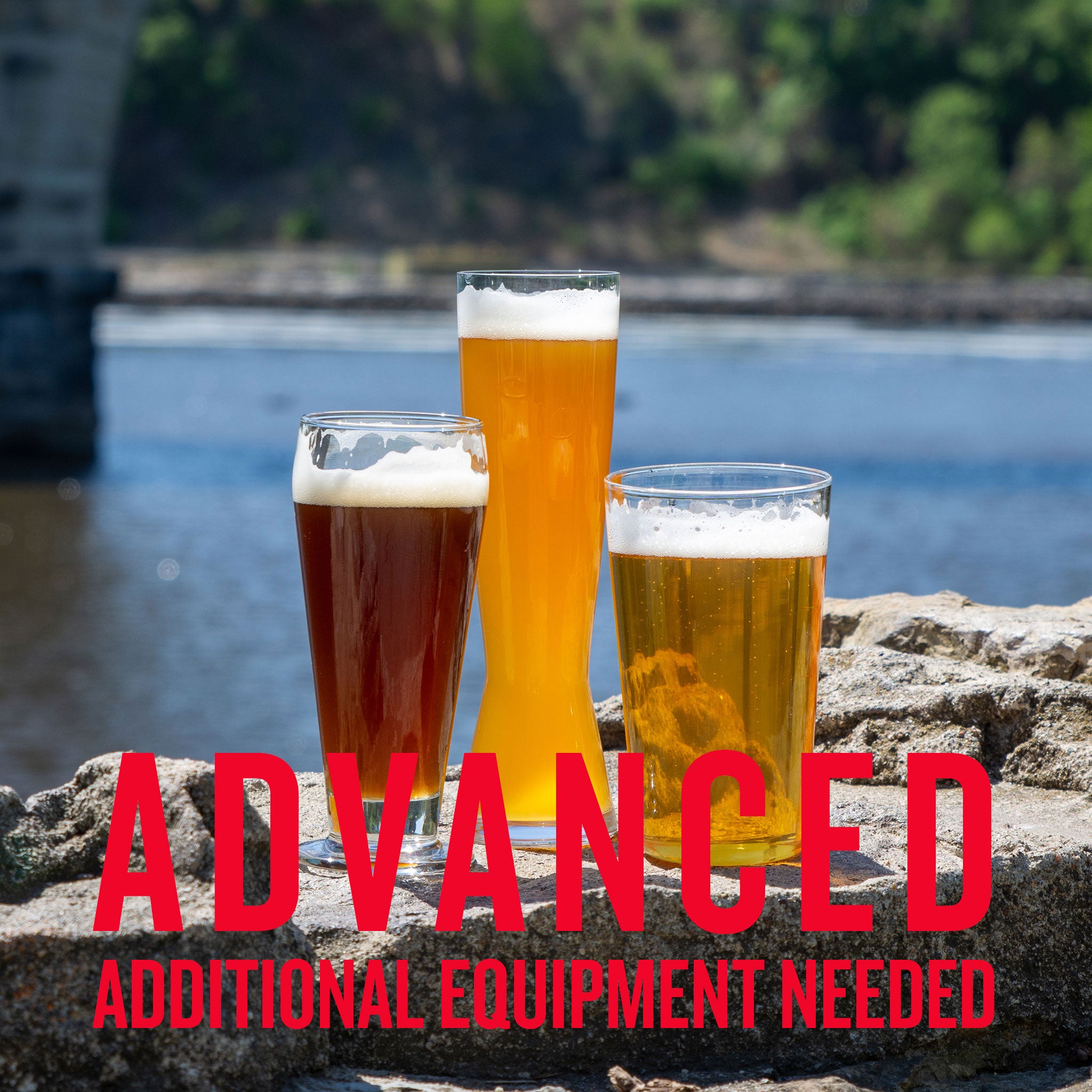 Three craft wheat beers—American Wheat, Bavarian Hefeweizen, and Dunkelweizen—served in tall glasses on a riverside rock ledge, with bold red text overlay reading 'ADVANCED ADDITIONAL EQUIPMENT NEEDED' indicating a complex homebrewing kit.