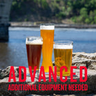 Three craft wheat beers—American Wheat, Bavarian Hefeweizen, and Dunkelweizen—served in tall glasses on a riverside rock ledge, with bold red text overlay reading 'ADVANCED ADDITIONAL EQUIPMENT NEEDED' indicating a complex homebrewing kit.