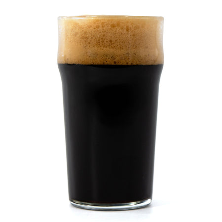 Glass of dark beer with a thick head on a white background