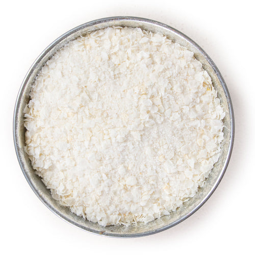 Pile of flaked torrefied rice in a small bowl.