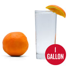 Navel Orange Hard Seltzer in a glass with an orange wedge and orange adjacent with 