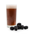 Pile of Blackberries next to a glass of Fruit Stand Wheat Beer