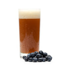 Blueberries next to Fruit Stand Wheat homebrew in a glass