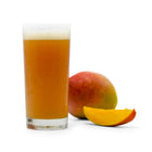 One whole and one sliced Mango next to a glass of Fruit Stand Wheat homebrew