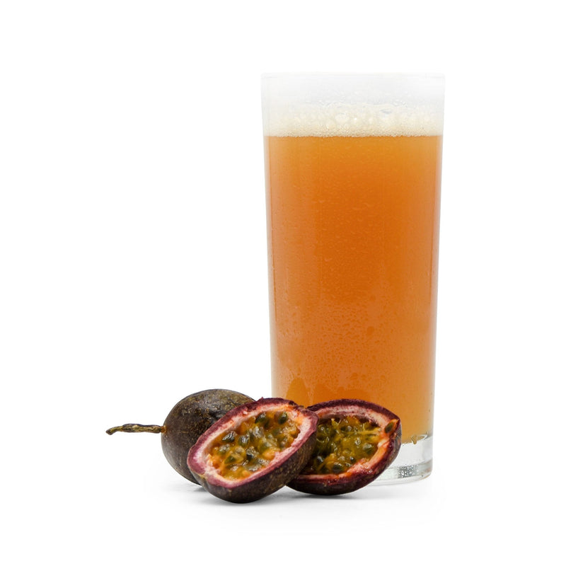 Sliced Passion Fruit beside Fruit Stand Wheat Beer in a glass