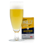 Philly Weisse in a glass with a pack of Philly sour yeast next to it.