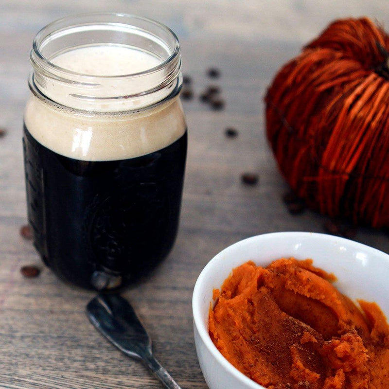 pumpkin spice latte stout beside a bowl of pumpkin spices